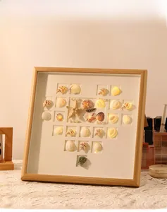 Detail of DIY seashell heart photo frame with warm LED lights and natural starfish