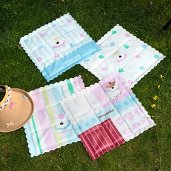 Outdoor grass display of cartoon animal pattern cooling mats with wavy edges for pets