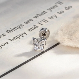 Delicate silver hollow butterfly stud earring with cubic zirconia on book pages