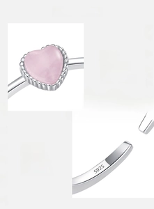 Close-up of S925 sterling silver ring featuring a pink heart-shaped cat eye stone detail