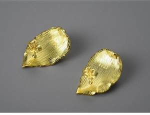 Macro shot of S925 sterling silver leaf earring with gold brushed texture and hallmark