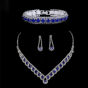 Detail shot of silver bridal jewelry set with blue zircons on a professional black background