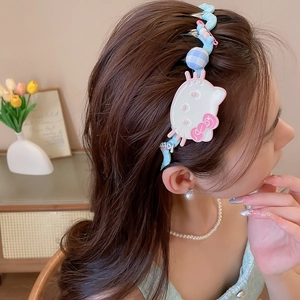Detailed view of a blue wavy fabric headband featuring cute Hello Kitty design accents