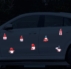 Detailed view of Christmas gnome magnetic car decals applied to a vehicle's blue door