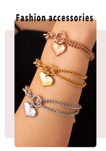 Detail of 18k gold plated stainless steel heart charm bracelets in three metal tones