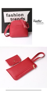 Detailed view of red pebble leather handbag set including crossbody, pouch and coin purse