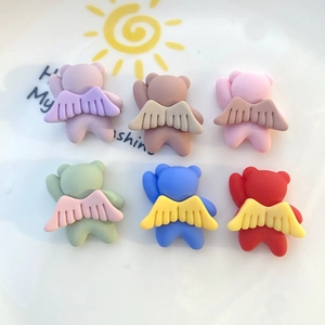 Flat lay of colorful resin mini winged bears for DIY phone cases and hair accessories