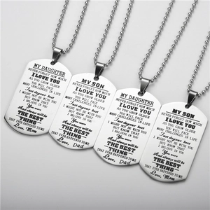 Macro detail of stainless steel dog tag pendants with inspirational engraved messages
