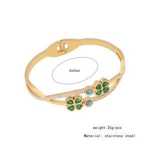 Detail view of gold stainless steel clover bangle with green crystals and measurements