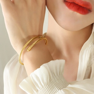 Minimalist gold twisted open bangle bracelet made of durable stainless steel for women
