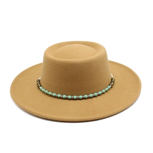 Detail of khaki wool felt flat top hat featuring a turquoise beaded decorative band