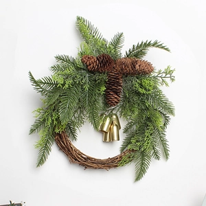 Detailed macro view of Christmas wreath featuring green pine needles, cones, and gold bells