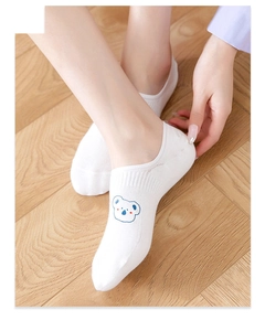 Close-up of white invisible boat socks with blue bear cartoon embroidery detail