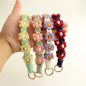 Handmade woven daisy flower wrist strap with gold spring clasps in four pastel colors