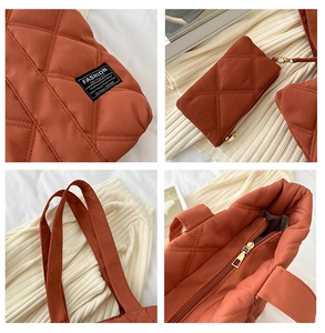 Detail view of terracotta quilted tote bag with matching coin purse and gold zipper