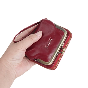 Macro shot of red lychee pattern leather mini purse with metal lock and zipper closure