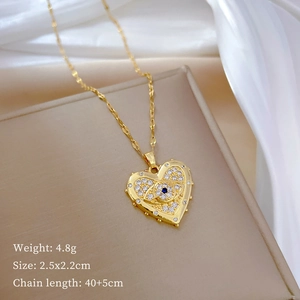 Detailed view of gold heart necklace with evil eye pendant and crystal pave setting