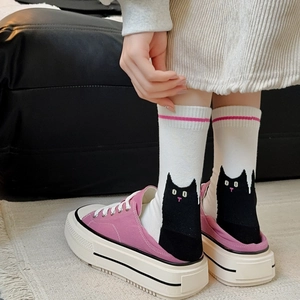 Detail of combed cotton mid-calf socks with black cat illustration and purple canvas shoes