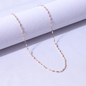 Detail of 18k gold-plated stainless steel lip chain necklace with pink enamel beads