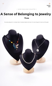 Three black bust necklace displays with natural wood bases in various heights on white back