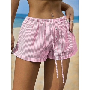 Women's pink striped casual shorts with elastic drawstring waist on beach background