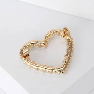 Detailed back view of a gold heart brooch showing a secure pin buckle mechanism