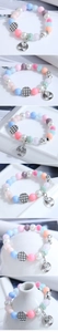 Detail of colorful beaded bracelet with silver Tree of Life charm and crystal accents