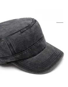 Close-up of wide brim and stitching on washed dark grey cotton flat top military cap