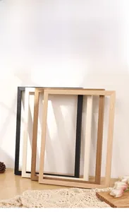 Detail showing four minimalist solid wood frames in black, white, light and dark wood tones