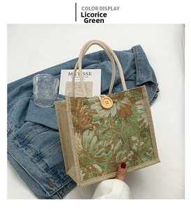 Close-up of licorice green floral linen tote bag with woven handles and wood button