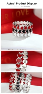 Detail of 925 sterling silver ring featuring triple heart design with red and black enamel