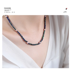 Detailed close-up of handmade necklace with natural lapis beads and pink freshwater pearls