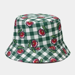 Close-up of green and white checkered bucket hat with detailed pink flower embroidery