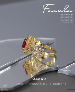 Macro view of gold ring with a red rectangular gemstone and shimmering pavé diamonds