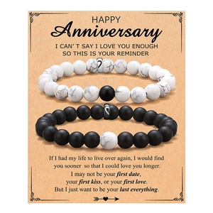 Matching couple beaded bracelets on anniversary gift card with meaningful English text