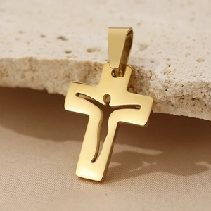 Macro shot of gold stainless steel hollowed cross pendant with detailed human silhouette
