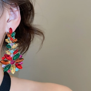 Close-up of vibrant multicolored crystal cluster flower earrings on a female model