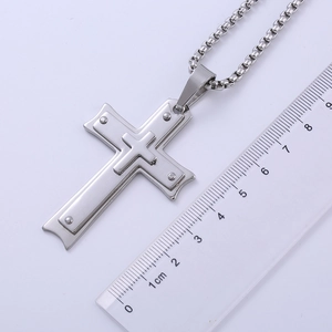 Detail of silver stainless steel triple layer cross pendant showing 5.5cm size measurement