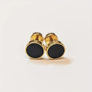 Detail of 8mm gold stainless steel stud earrings with black round resin inlay