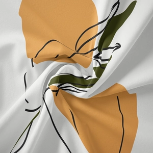 Close-up of bohemian tapestry fabric showing abstract orange shapes and green plant silhouettes