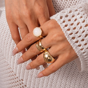 Minimalist gold tone geometric resin ring set with dome and gemstone designs