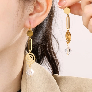 Golden titanium steel spiral drop earrings with crystal pendant on a female model