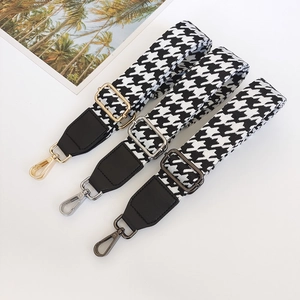 Adjustable houndstooth shoulder strap with gold, silver, and gunmetal hooks