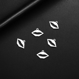 Five silver stainless steel lip pendants on black leather background, 18K gold plated DIY craft