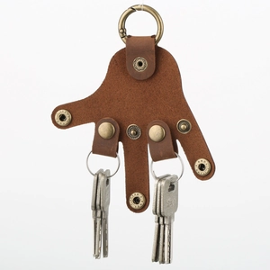 Brown genuine leather palm-shaped keychain with vintage metal snaps on a white background