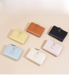Flat lay of colorful macaron bifold wallets in textured leather with snap buttons