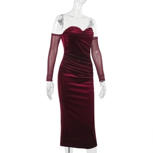 Close-up of wine red velvet dress with ruched texture and matching mesh sleeves