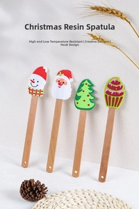 Close-up of Christmas silicone spatulas showing wooden handle and hanging hook detail