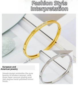 Detail view of stacked gold and silver minimalist bangles with center-set cubic zirconia stones