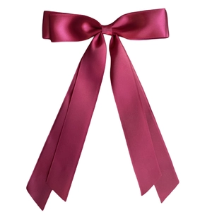 Elegant wine red satin ribbon bow hair clip with long streamers on white background